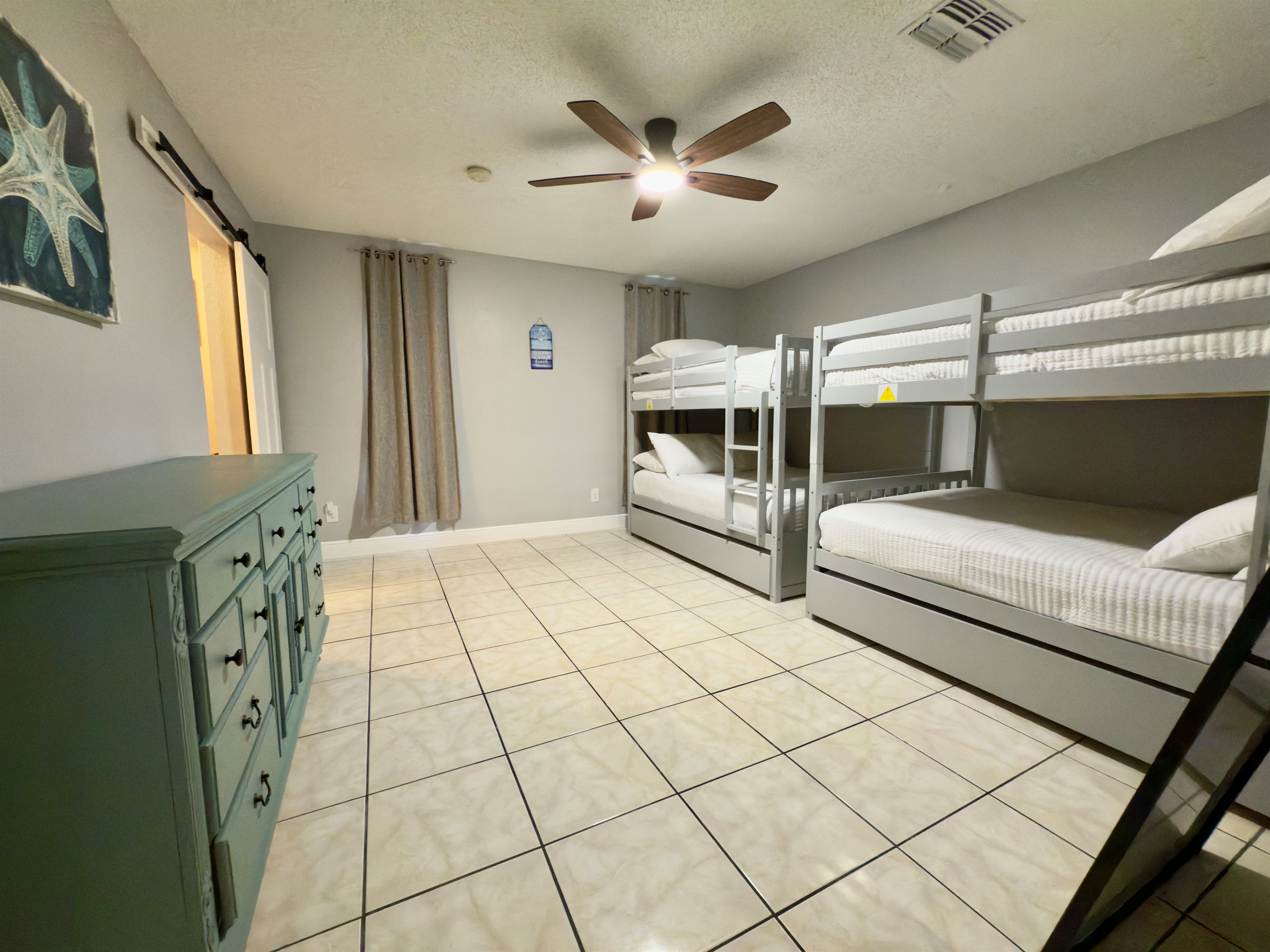 Whether you’re traveling with kids, cousins, or a crew of friends, this generously sized bunk room offers the perfect blend of comfort, space, and playful charm.