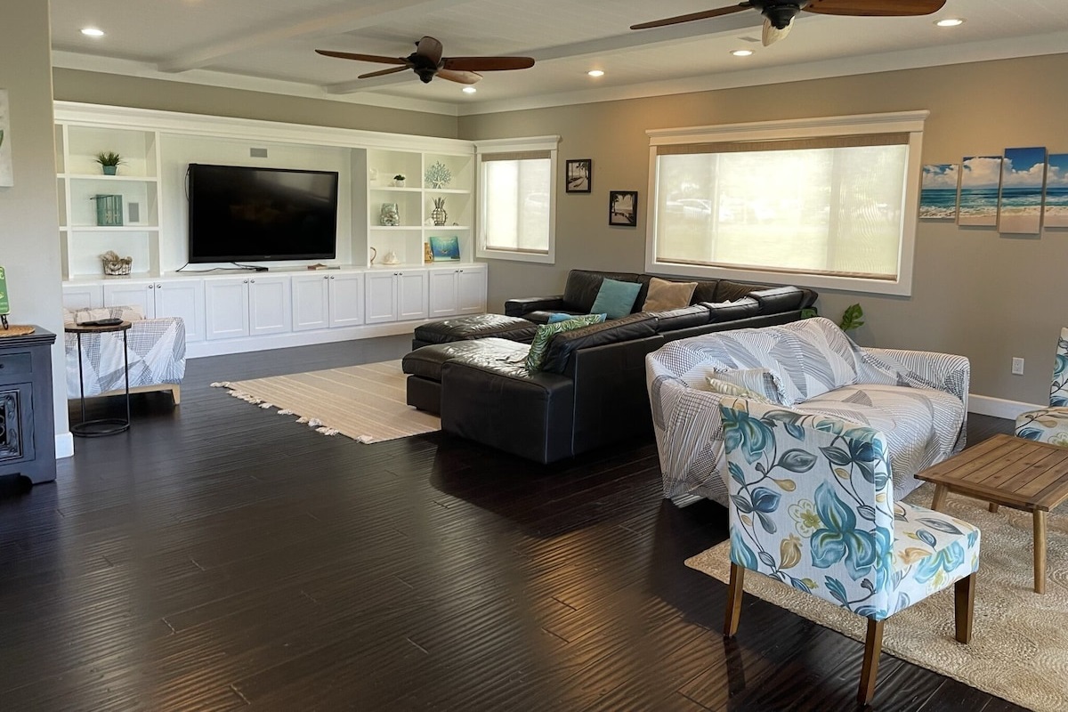 Living room with big leather couch and 70" TV