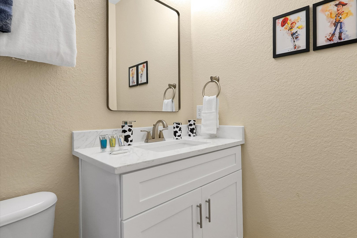 Toy Story Ensuite: Bright private bathroom with a modern vanity and shower for Toy Story Adventure guests.