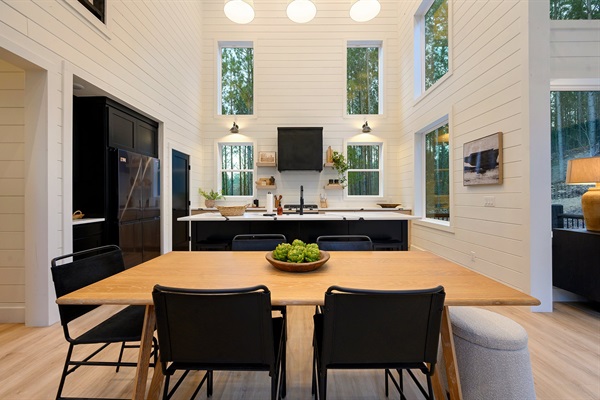 The dining table sits just steps from the kitchen, perfect for shared meals and late-night conversations.