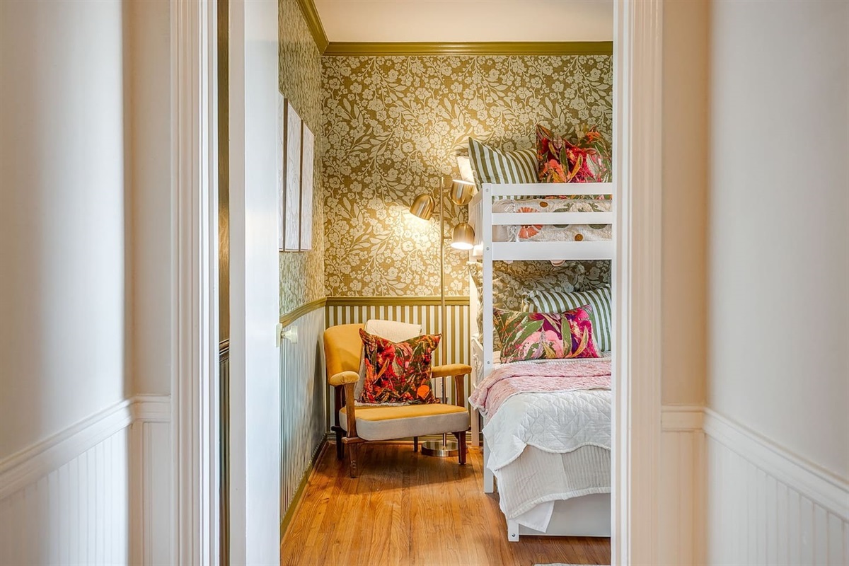 Bedroom Two coming into view — comfy king bunk, cozy reading chair, and details that make this space feel anything but ordinary.