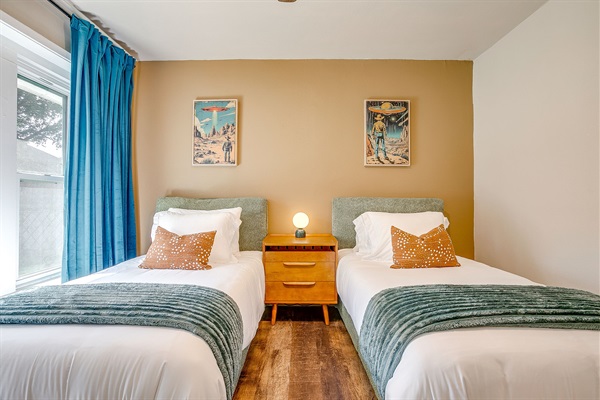 Comfortable twin beds with stylish decor and natural light for a peaceful stay