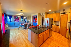 Vast kitchen and dining space overlooking a charming patio, offering a delightful atmosphere for dining and unwinding
