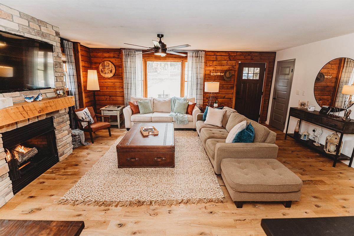Sink into plush sofas in the cozy living room with 55" smart TV, perfect for movie nights or a relaxing evening by the fire