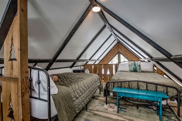 Sleep under the peaks in your cozy loft—twin beds, rustic beams, and a snug space designed for you and yours to rest and recharge.