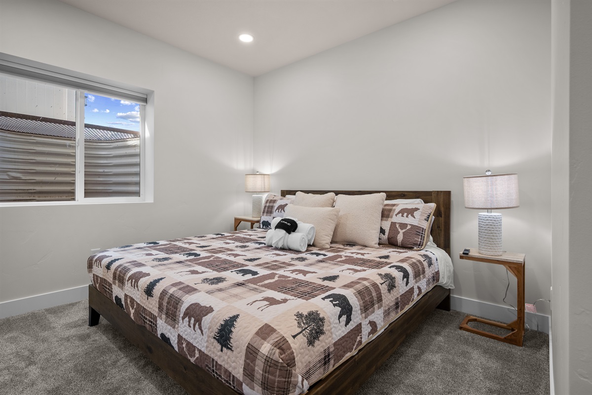 Primary bedroom with king bed, soft linens, and calming mountain tones.