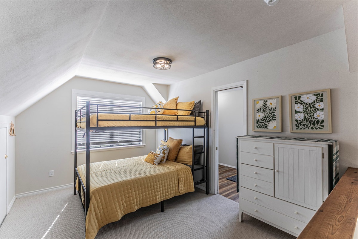 Upstairs open loft bedroom with queen bunk beds and full bathroom.