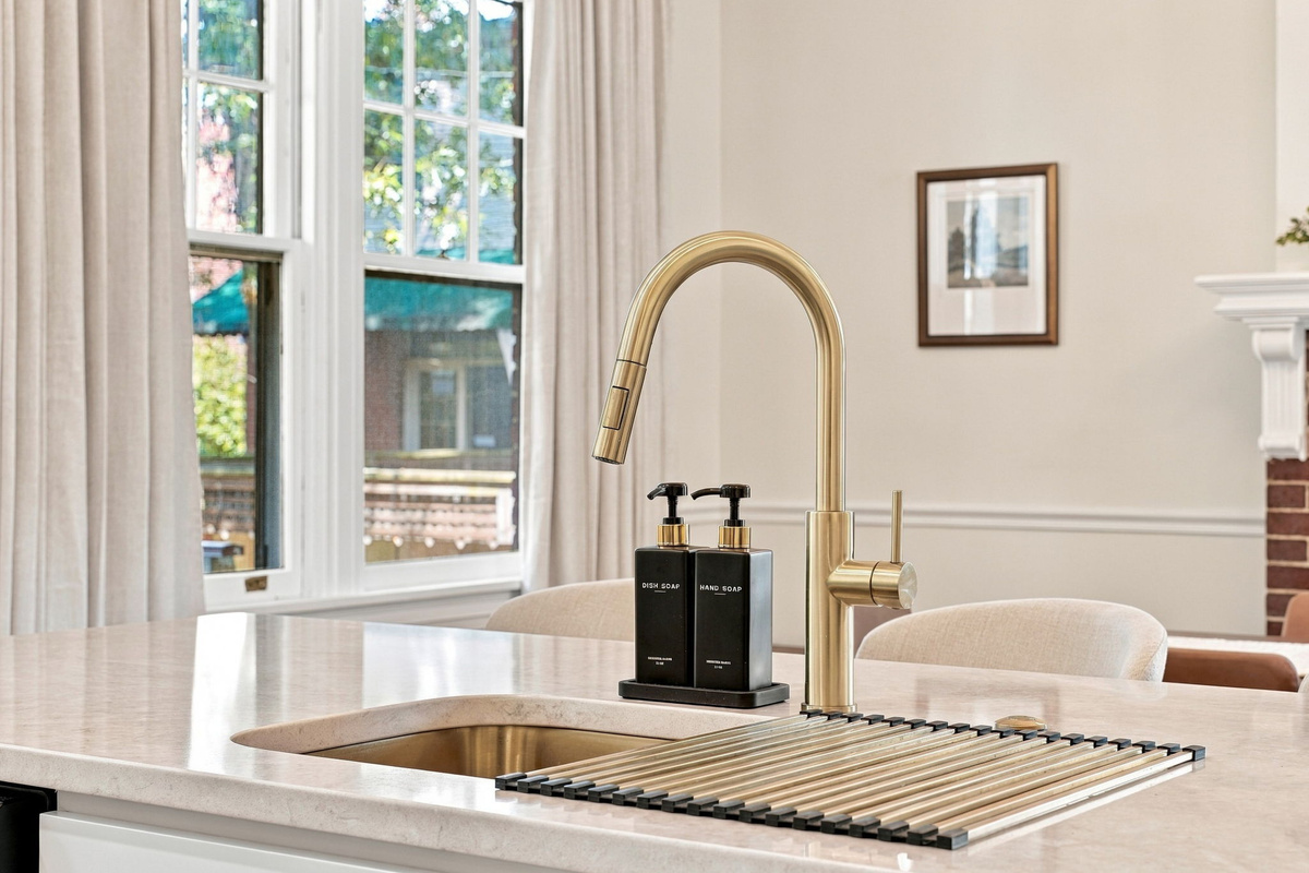 Kitchen Oasis: Elegant brass accents highlight sleek surfaces, perfect for culinary adventures!