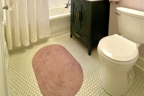 Charming bathroom with original tile flooring and fresh, modern updates.