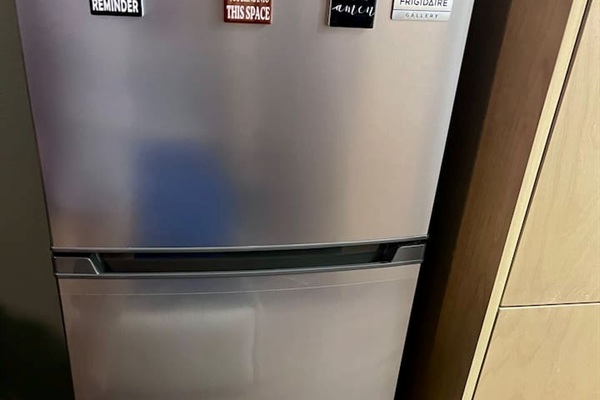 Full-size refrigerator in the kitchenette for storing snacks, drinks, and simple meals.
