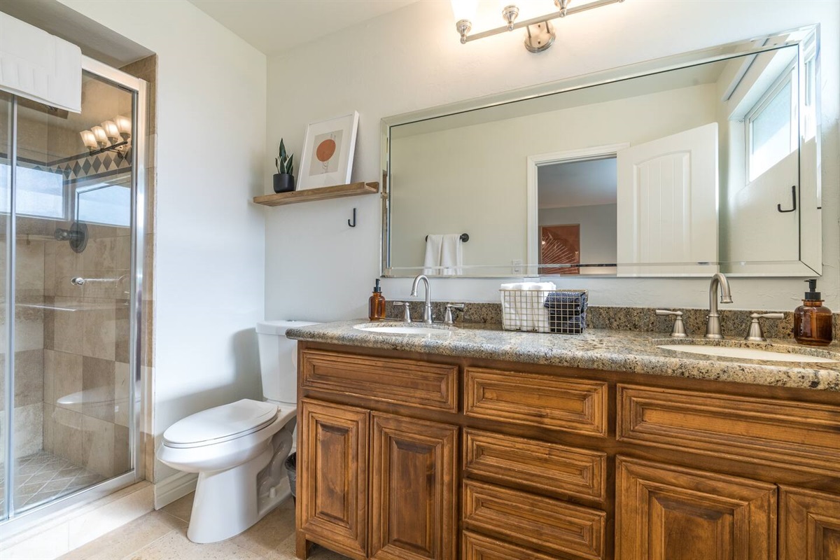 Main bedroom's ensuite bathroom has double sinks and shower. 