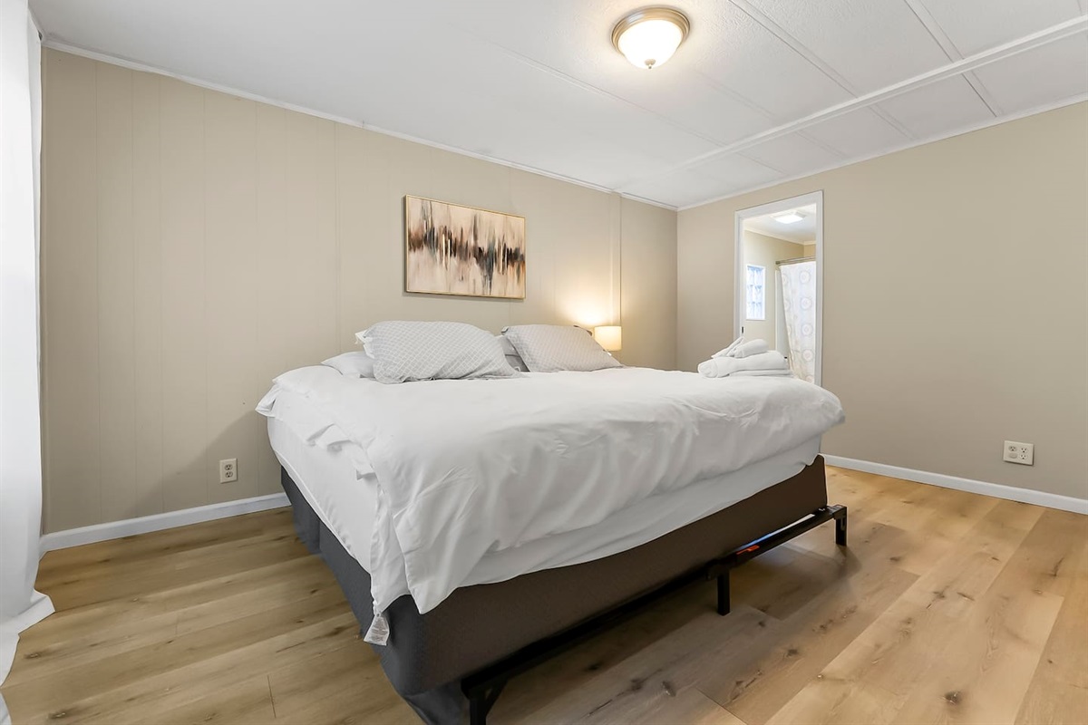 Comfortable king bed with fresh linens, perfect for a restful night’s sleep.