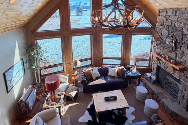 Experience the heart of the home in this breathtaking great room!  The dramatic wall of windows, stone fireplace and cozy seating make it a perfect place to unwind and connect. As one of our guests said, ‘This house is a vacation unto itself!'