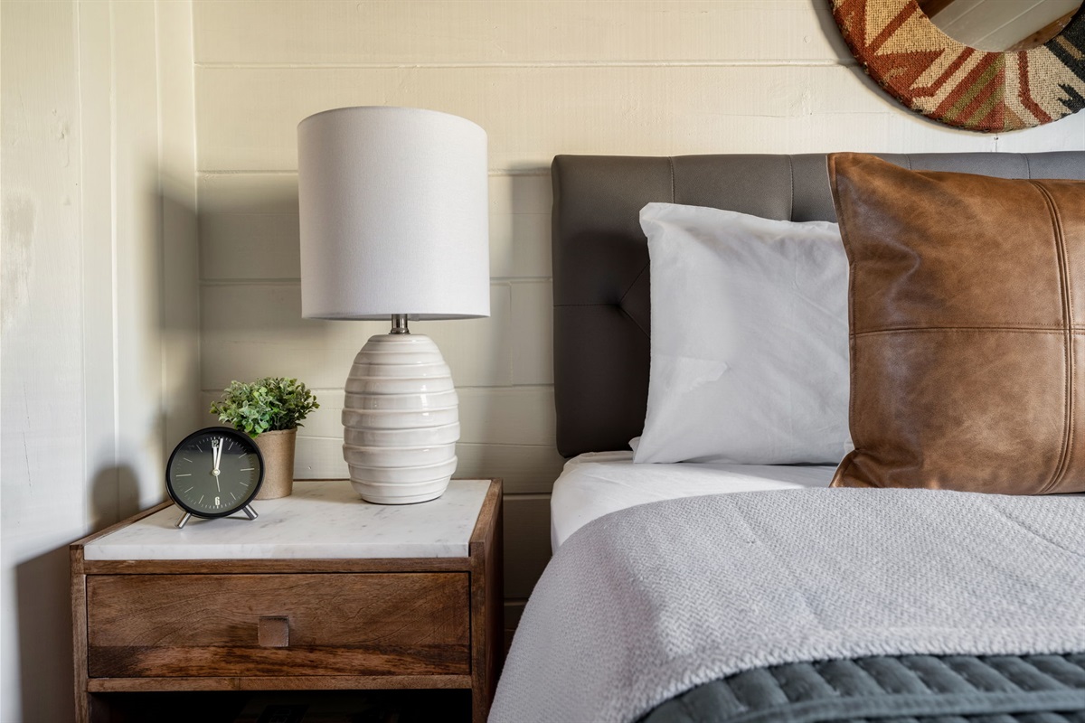 Cozy up with a good book under the soft glow of our bedside table lamp