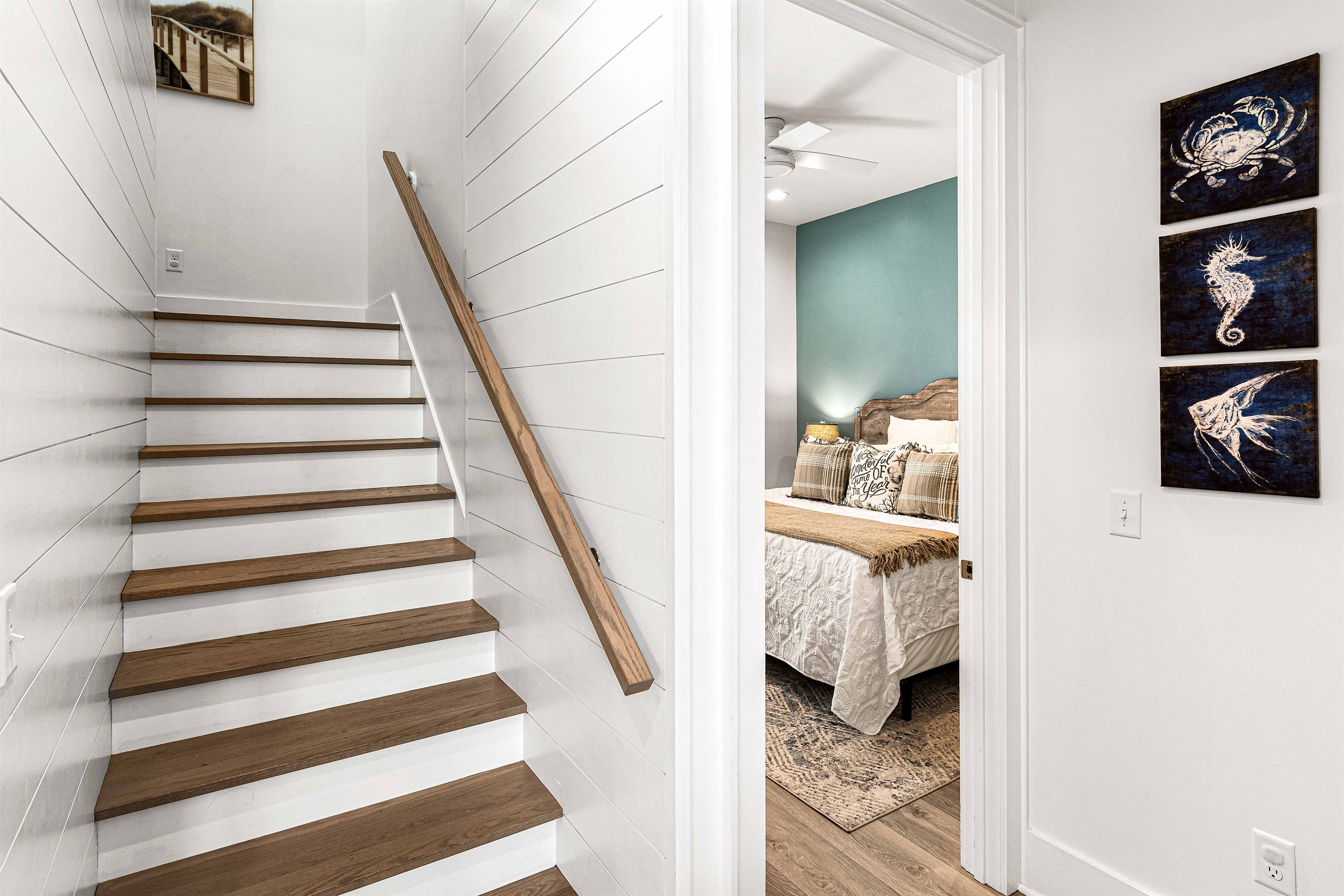 As you walk upstairs to the top level, the landing provides access to three more bedrooms, all with private bathrooms, and the washer/dryer.