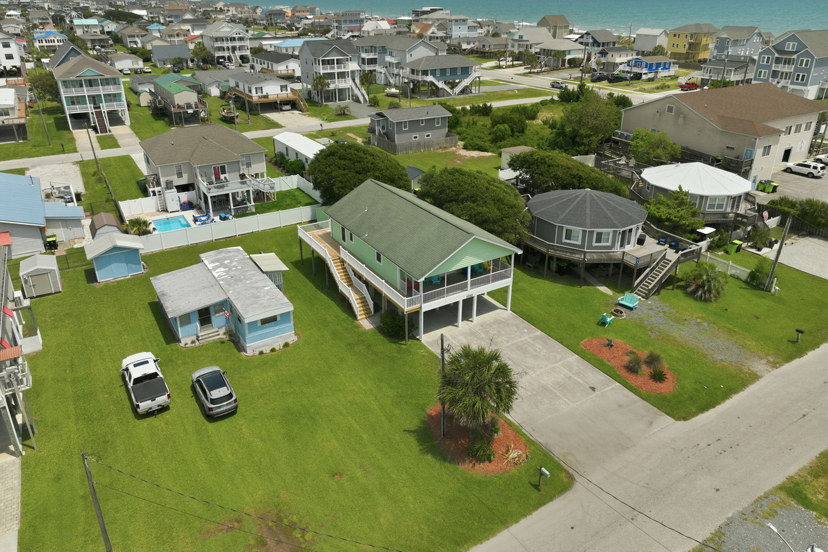 Wide aerial perspective featuring the home's location near the beach with easy access to local attractions