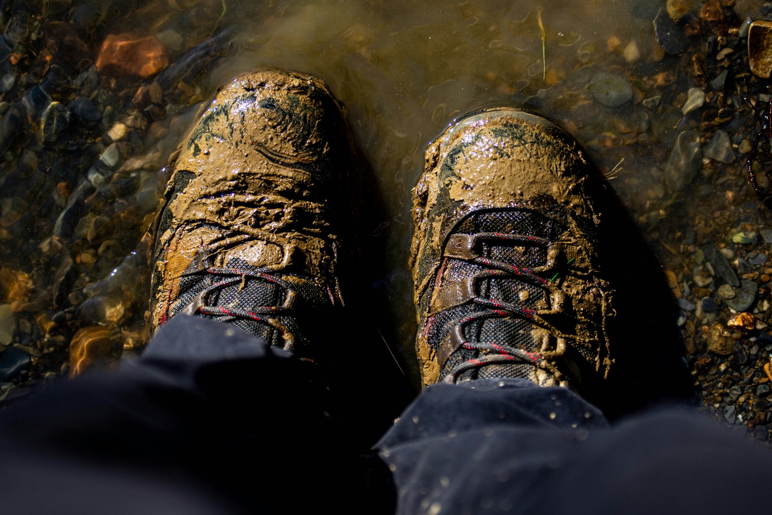 Muddy hiking boots after rain on a March trail in Hocking Hills