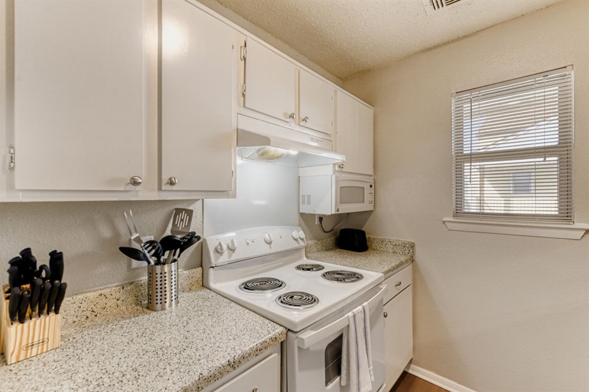 Bright and compact kitchen with clean white finishes and modern touches.