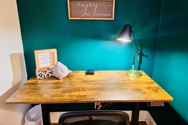 Power up your productivity—Queen’s Landing features an electric standing desk with built-in outlets and charging ports, paired with a comfortable chair for work or winding down.