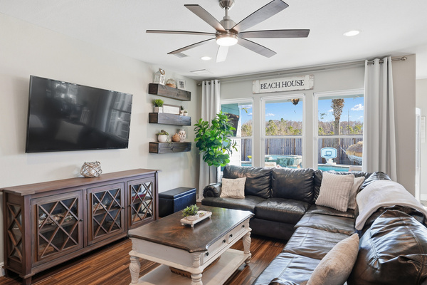 Spacious living room with easy flow to the kitchen, dining area and outdoor amenities.