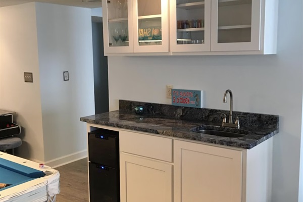 The game room and living area features a wet-bar for all your vacation cocktail needs!