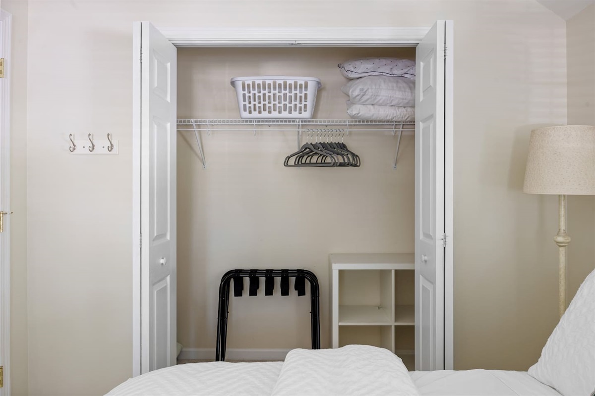 Ample storage space with luggage racks, hangers, laundry basket and extra pillows. 
