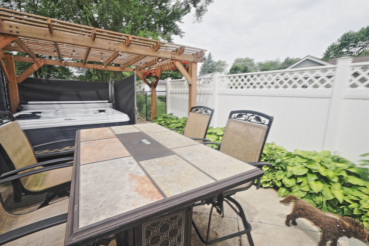 Patio with pergola, fire table, and hot tub!