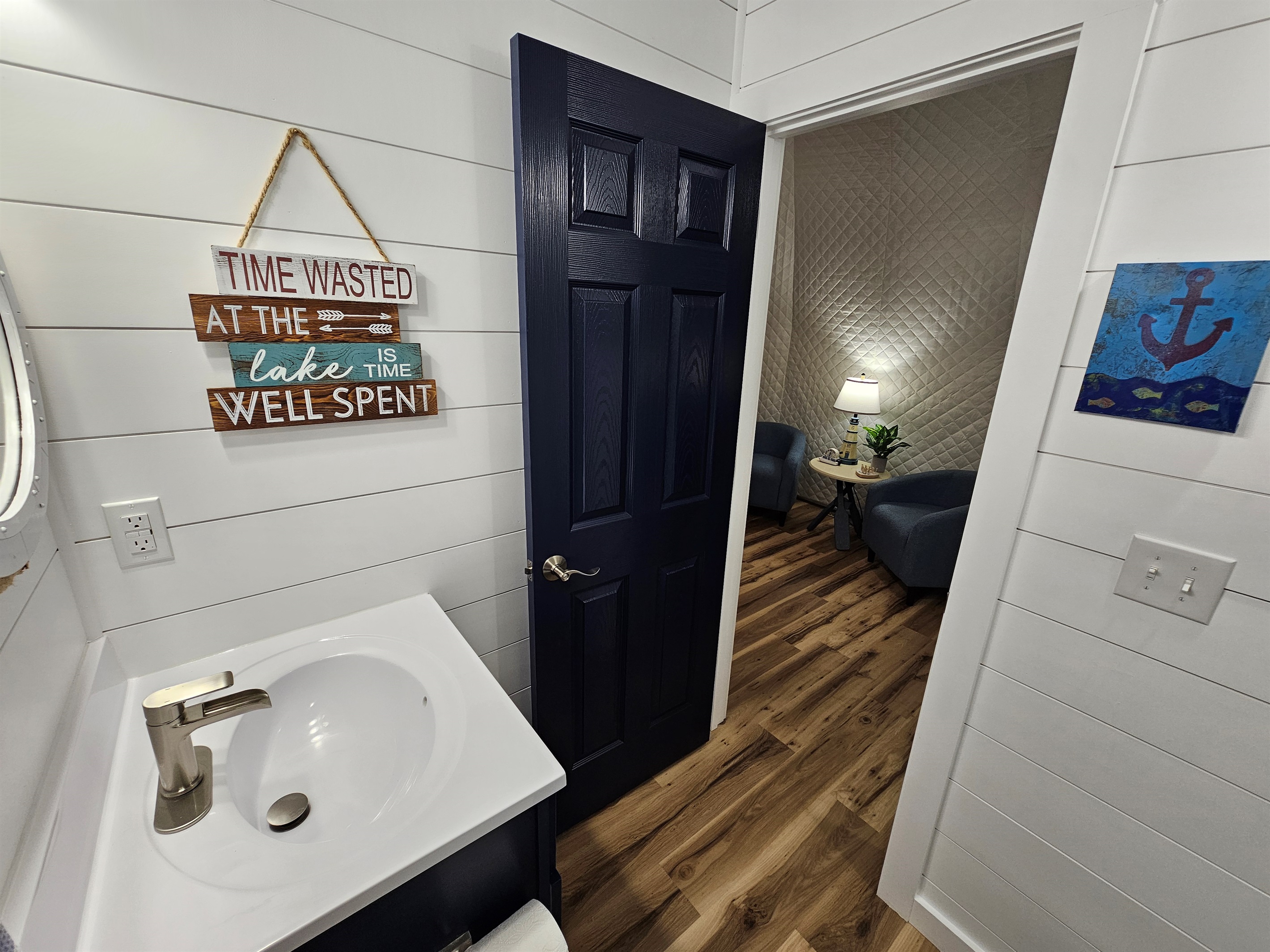 Bright, clean bathroom with lake-themed décor and convenient access to the main dome living space