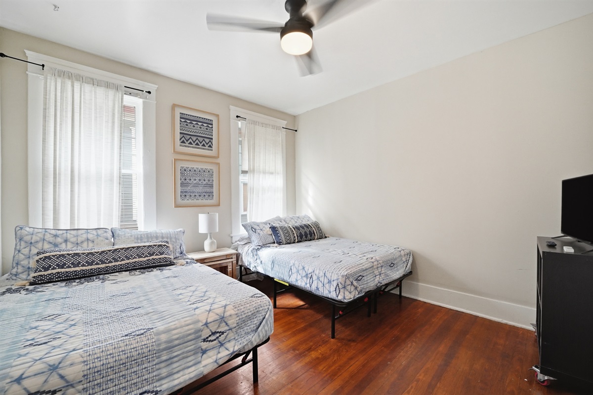 Guest bedroom with 2 full size beds and TV