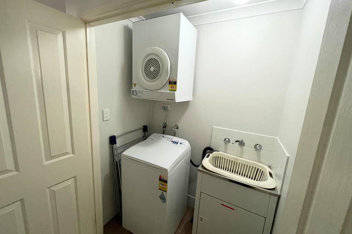 European laundry with top load washing machine and clothes dryer