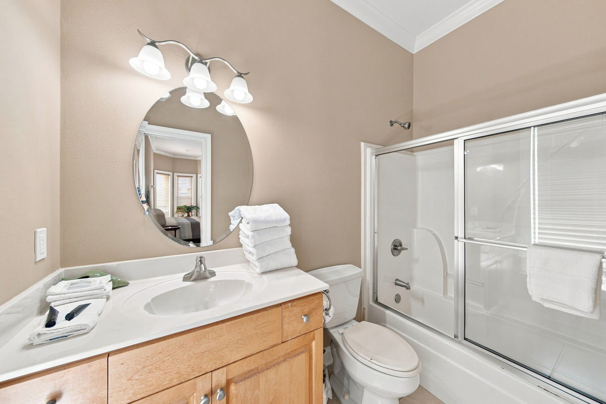 Full bathroom with a vanity and framed mirror