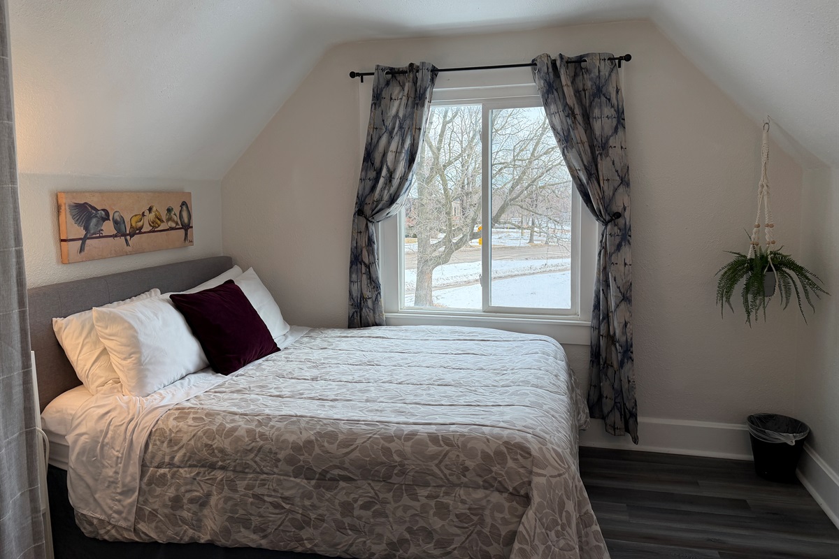The upstairs queen bedroom overlooks the quiet cul-de-sac.