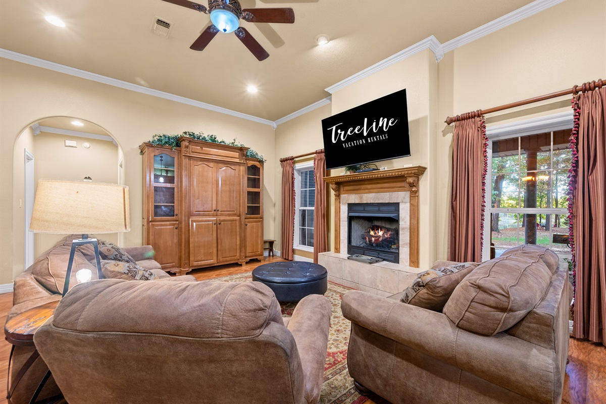 Cozy living room featuring a fireplace and plush seating.