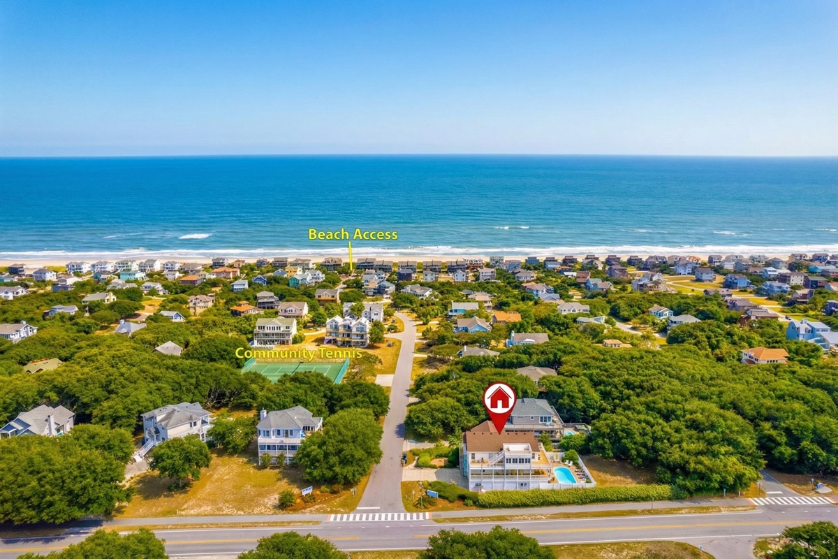 An aerial drone shot highlighting Southside Pearl's location, showing the short walk to the beach access and proximity to community tennis courts.