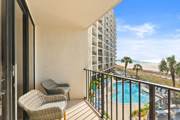 Private balcony overlooking the pool and beach