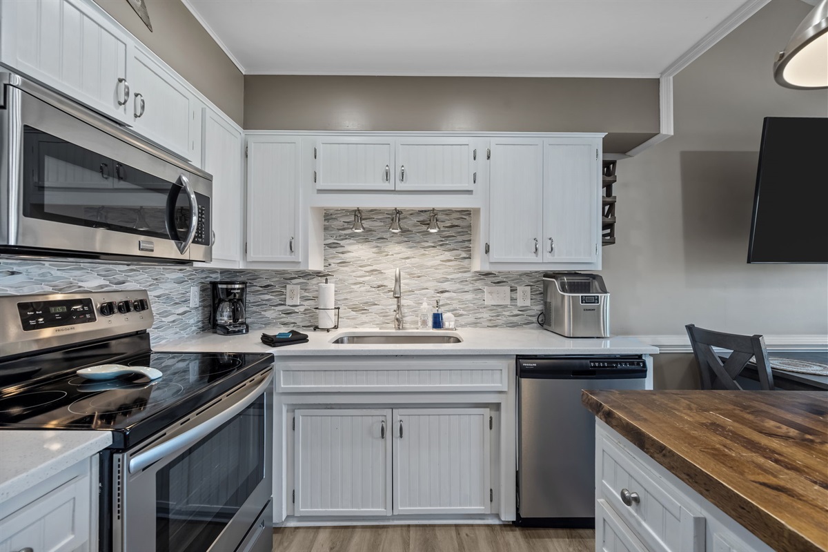 Full kitchen with stainless appliances and coffee maker