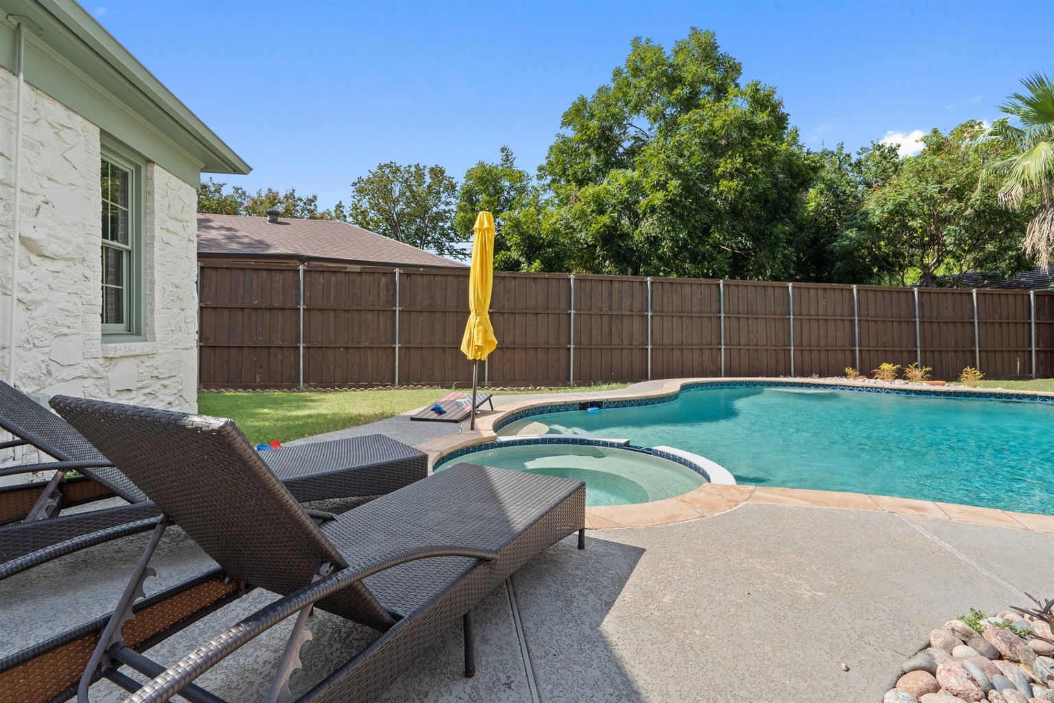 Unheated Pool and fully fenced backyard with sun loungers, umbrella, and patio seating. Outdoor oasis for groups of up to 10. Shared between main house and Detached Studio guests.