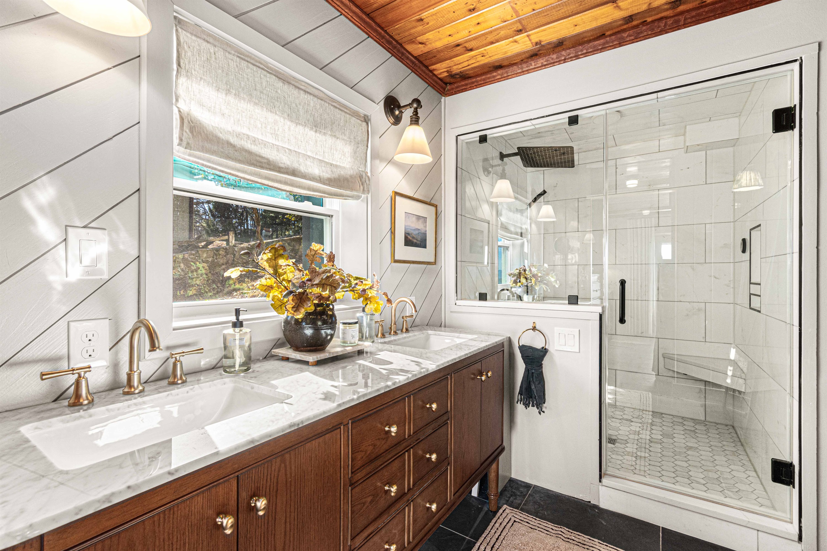 The updated primary bathroom blends modern finishes with classic style, featuring a spacious vanity and a bright, walk-in shower for a fresh, spa-like feel with a steam shower!