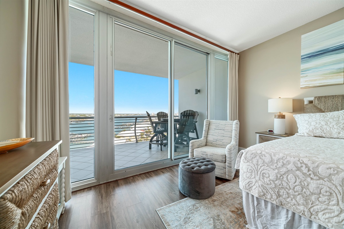 Experience the ultimate in comfort and style in this elegant Primary bedroom. Featuring a cozy king-sized bed, tranquil color palette, plush furnishings, and breathtaking views, this space offers a peaceful sanctuary for relaxation.