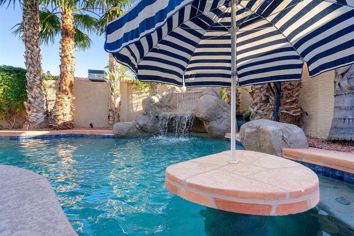 Tiki bar with build in seating and umbrella.