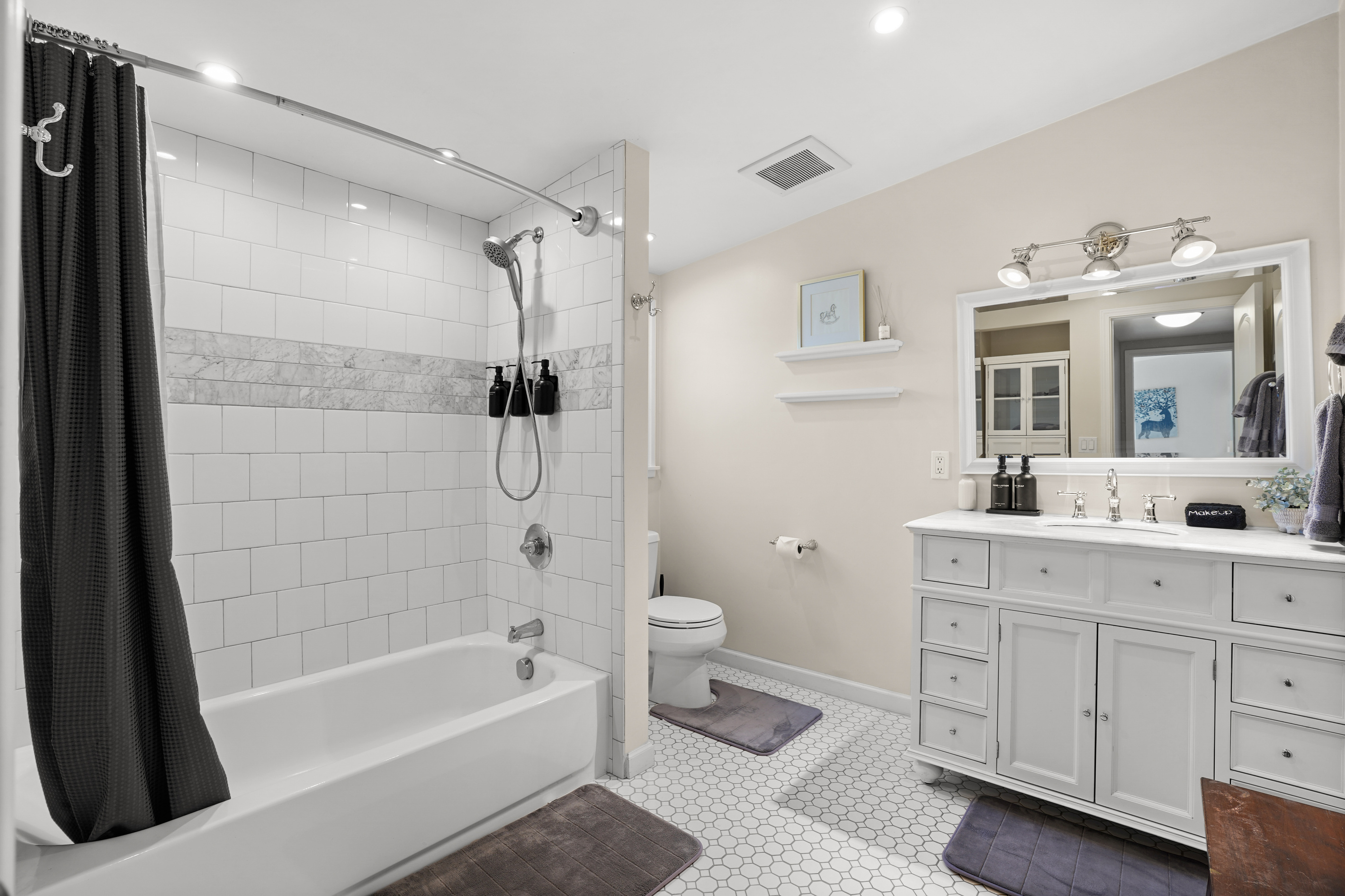 This full bathroom features a bathtub and is stocked with fresh towels and essential amenities, providing a comfortable space to refresh and unwind during your stay.