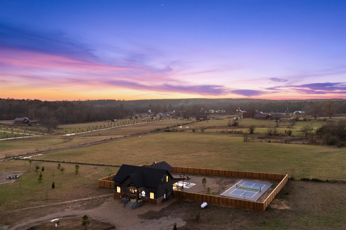 This overhead shot captures the entire property, from the pool to the play areas to the wide-open outdoor spaces.