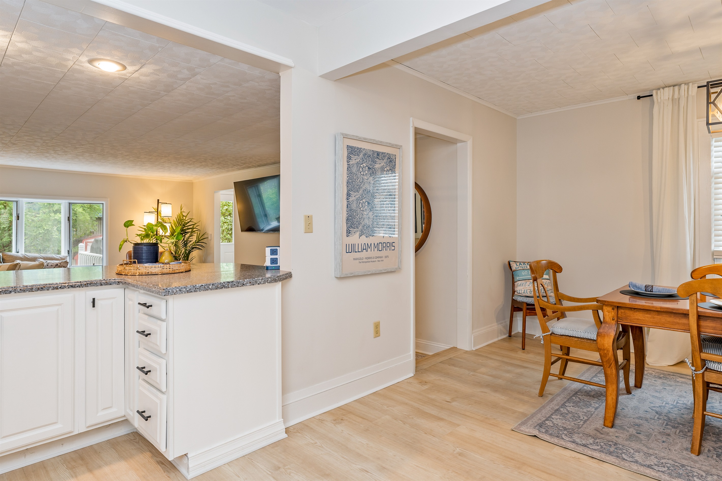 Open-concept kitchen with breakfast bar and scenic views into the cozy living room—ideal for entertaining and relaxing.