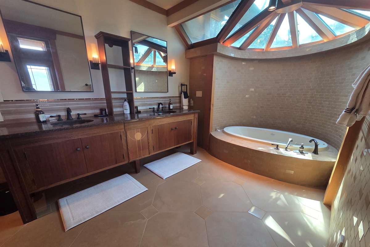 The master bathroom offers a spa-like experience with a deep soaking tub and a large walk-in shower designed for comfort and relaxation.