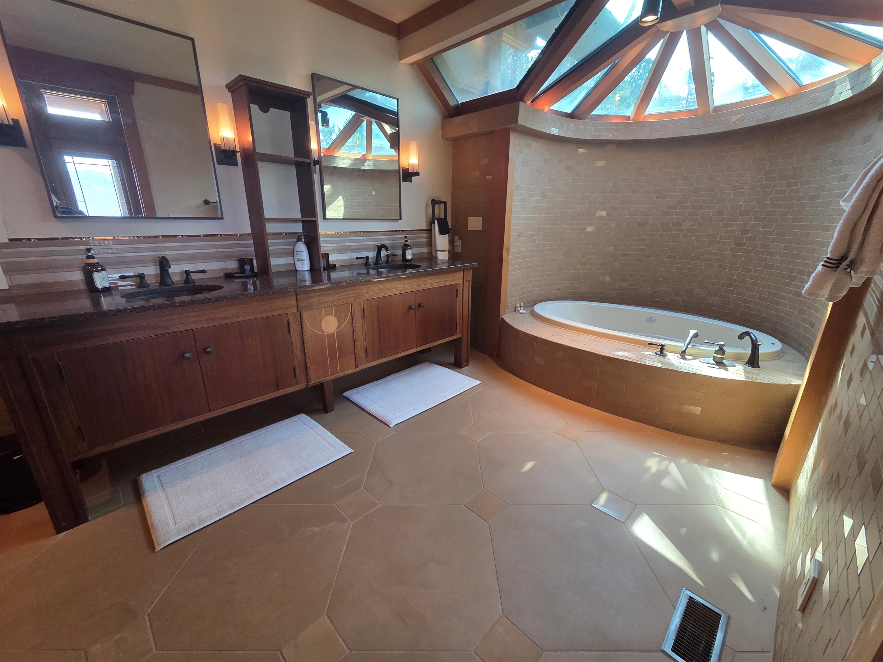 The master bathroom offers a spa-like experience with a deep soaking tub and a large walk-in shower designed for comfort and relaxation.