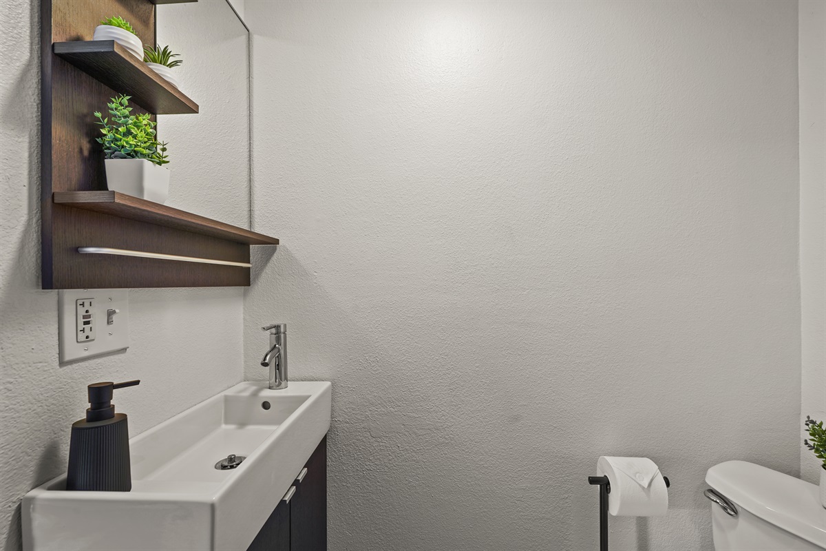 Fully renovated studio bathroom with modern finishes, a walk in shower, fresh towels, and a clean spa like feel.