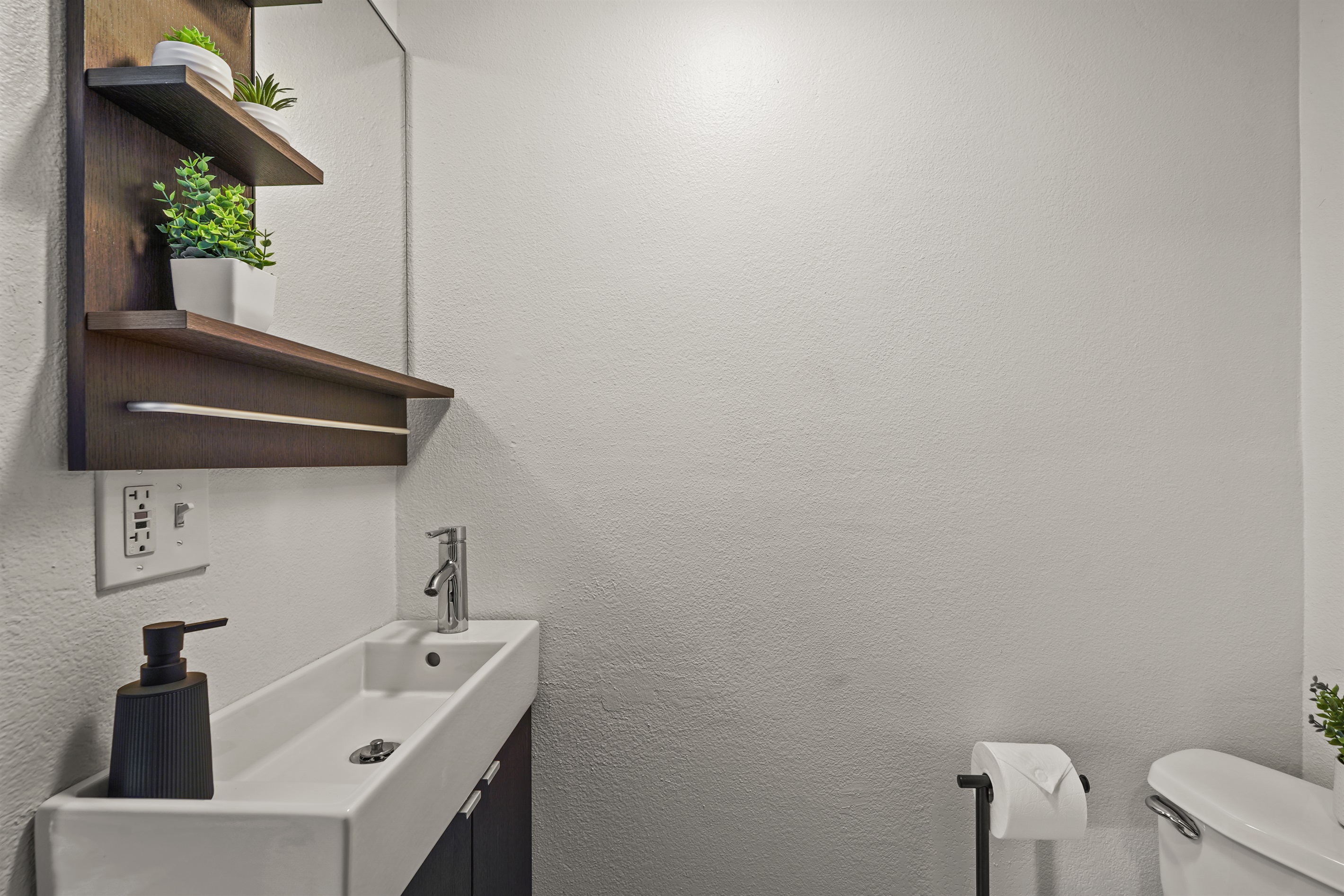 Fully renovated studio bathroom with modern finishes, a walk in shower, fresh towels, and a clean spa like feel.