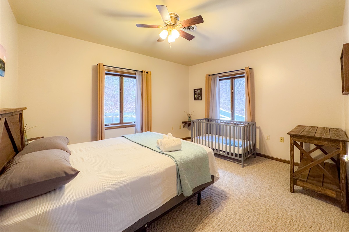 The scenic drives themed bedroom is setup for those with an infant. Complete with room darkening curtains, a crib and a changing table.