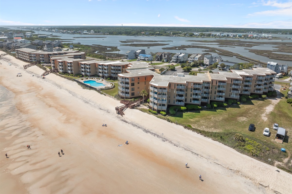 Oceanfront complex with pool, beach access, and scenic views