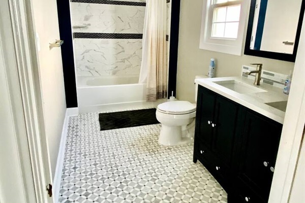 Large full bathroom with double sink.